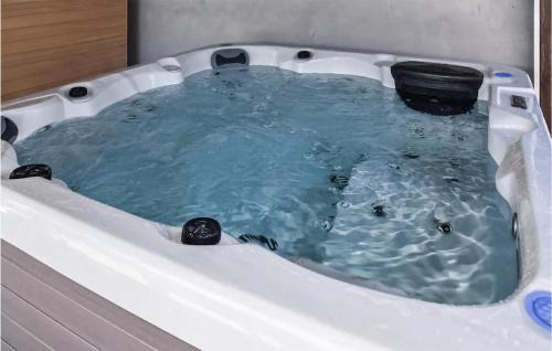 比奥格勒·纳·莫鲁Cozy Home In Biograd Na Moru With Sauna的按摩浴缸内有黑桶