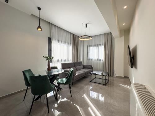 a living room with a couch and a table and chairs at VILLA 8 By ProLiving Hospitality in Thessaloniki