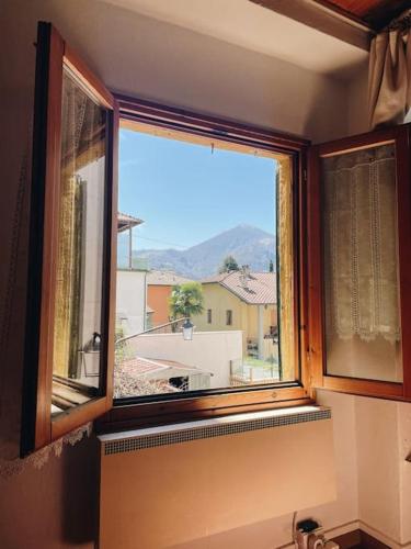 a window in a room with a view of a city at Dolce Barzio - piccolo bilocale in Barzio