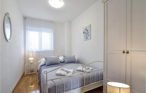 a bedroom with a bed with blue pillows on it at 4 Bedroom Gorgeous Home In Hrvace in Hrvace