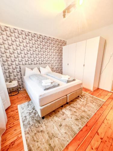 a bedroom with a bed and white cabinets and a rug at Luxuriöses Bauernhaus mit Garten und Parkplatz in Straß in Steiermark