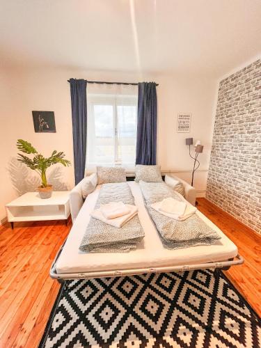 a large bed in a room with a large window at Luxuriöses Bauernhaus mit Garten und Parkplatz in Straß in Steiermark