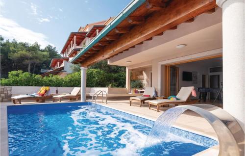 a swimming pool in a backyard with a house at Nice Home In Prizba With Sauna in Prizba