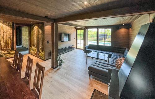 a living room with a couch and a television at Cozy Home In Äspered With Sauna in Dalsjöfors