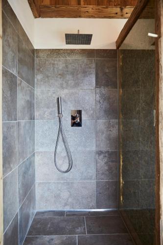 a bathroom with a shower with a shower head at Dreisessel-Chalets im bayerischen Wald - Chalet Dreisessel mit Whirlpool-Sauna-Kamin in Haidmühle