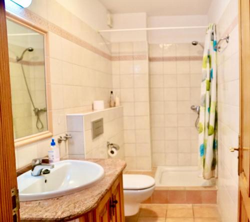 a bathroom with a sink and a toilet at Family and Friends , Familienapartment Playa de San Juan in Guía de Isora