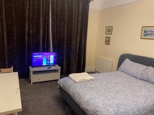 a bedroom with a bed and a tv on a table at The Florence Room in Norwood