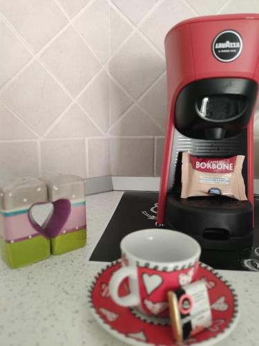 a coffee maker and a cup on a counter at ross house in Fiumicino
