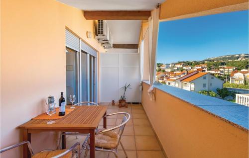 a balcony with a wooden table and chairs and a window at 1 Bedroom Cozy Apartment In Palit in Palit