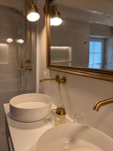 a bathroom with a sink and a mirror at Évasion champêtre in Ambillou