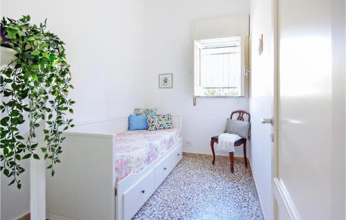 a small bedroom with a bed and a chair at Nice Home In Cava D'aliga With Wifi in Cava dʼAliga