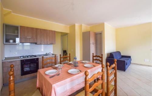 a kitchen with a wooden table and a blue chair at Amazing Home In Melito Porto Salvo in Melito di Porto Salvo
