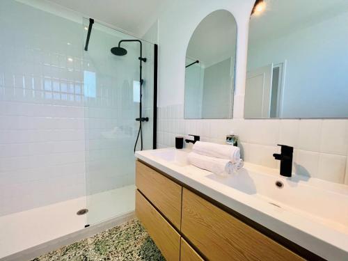 a bathroom with a sink and a shower at L'Orée du Golf - Maison Deauville 8 personnes in Saint-Arnoult
