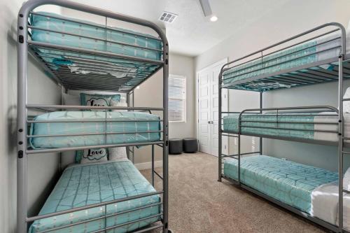 a room with three bunk beds in it at 30-31| 2 Homes in St George with Private Pools and Hot Tubs in Santa Clara
