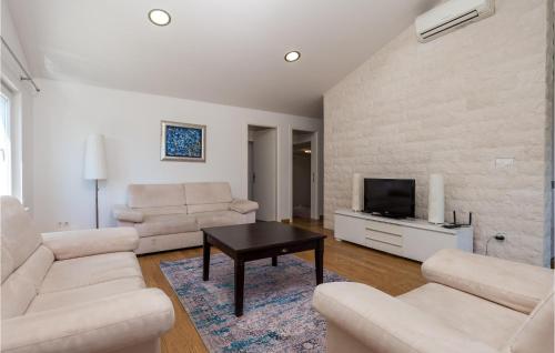 a living room with a couch and a tv at 3 Bedroom Cozy Home In Krk in Krk
