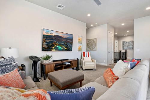 a living room with a couch and a desk at 30-31| 2 Homes in St George with Private Pools and Hot Tubs in Santa Clara
