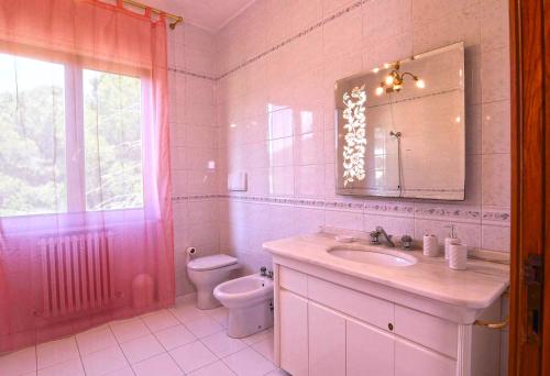 a bathroom with a sink and a toilet and a mirror at Appartamento a Perugia in Perugia