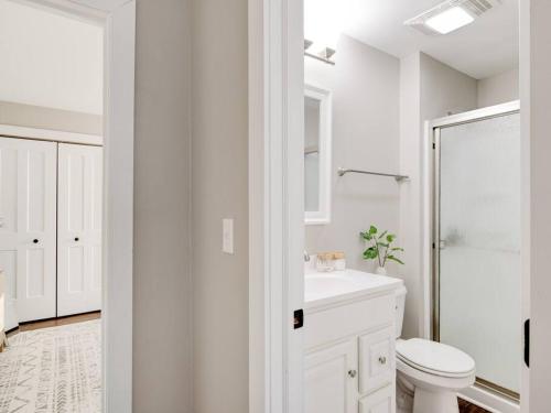 a white bathroom with a toilet and a sink at Cozy 1-Bedroom Retreat, New Remodel, Fast Wi-Fi in Columbus