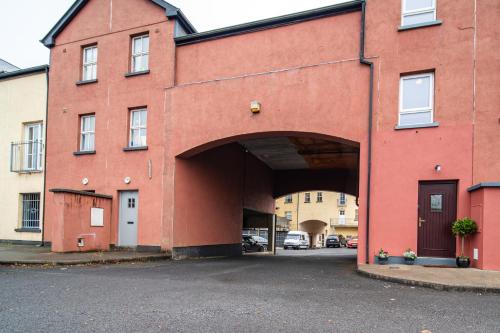 a large red building with a large archway at Teach Saoire in Ballina