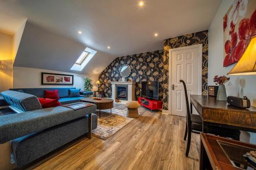 a living room with a blue couch and a table at Teach Saoire in Ballina