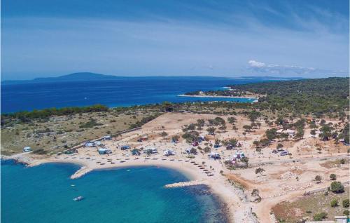 an aerial view of a beach with people in the water at Lovely Apartment In Kustici With Wifi in Kustići