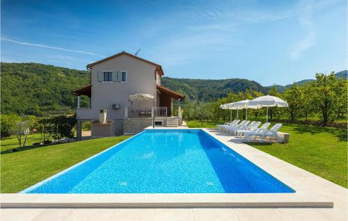 a villa with a swimming pool in front of a house at Villa Alba in Motovun