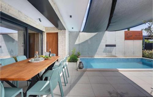a dining room with a table and a swimming pool at Villa Monte Grosso in Pula