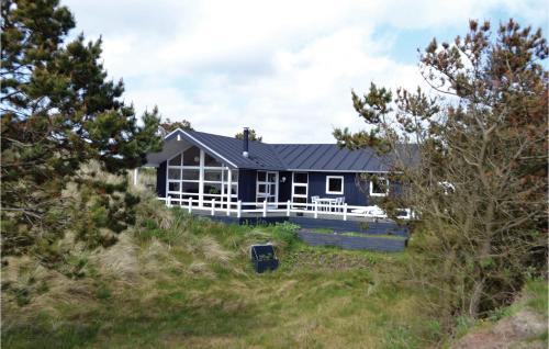 a house on top of a hill with trees at Holiday Home Henne With A Fireplace 08 in Henne Strand