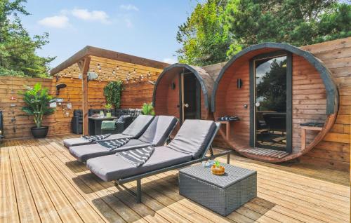 a wooden deck with chairs and a circular house at Lovely Home In Thisted With Sauna in Thisted