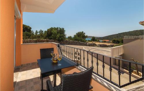 a balcony with a table with wine glasses on it at Cozy Apartment In Sevid With Wifi in Sevid