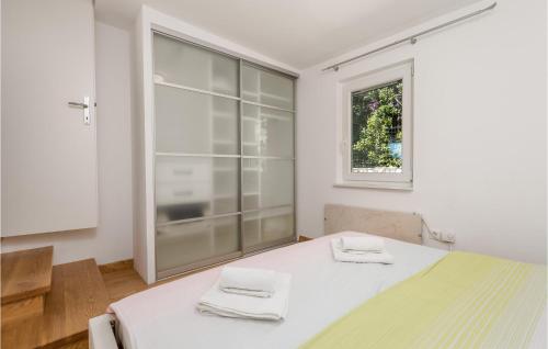 a white room with a table and a window at 3 Bedroom Cozy Home In Krk in Krk