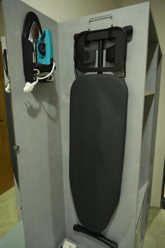 a bathroom with a black toilet in a room at SKD RESORT AND CLUB in Barvāla