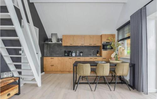 a kitchen with a table and chairs and a staircase at 3 Bedroom Gorgeous Home In Kerkdriel in Kerkdriel