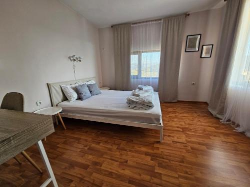 a bedroom with a bed and a wooden floor at Apartment 22 in Veliko Tŭrnovo