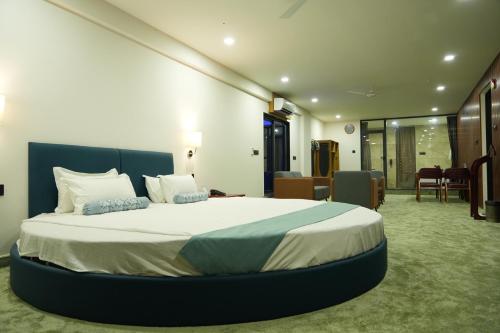 a bedroom with a large bed in a room at SKD RESORT AND CLUB in Barvāla