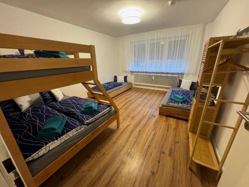 a room with three bunk beds and a window at Große Freiheit in Ellzee