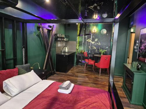 a room with a bed and a table in it at Make Love Apartament by Secret Apartament in Toruń
