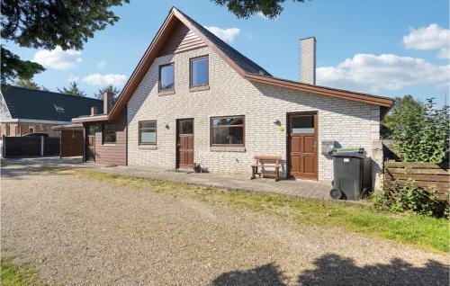 a house with a gravel driveway in front of it at 3 Bedroom Awesome Home In Nørre Nebel in Nørre Nebel