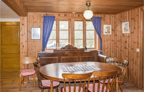 a dining room with a table and a piano at Pet Friendly Home In Ryd With Kitchen in Ryd