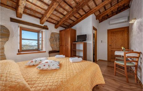 a bedroom with a bed with pillows on it at Cozy Apartment In Cerovlje With Wifi in Cerovlje