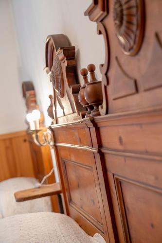 a bedroom with a wooden bed and a wooden dresser at Camere vecchio borgo in Bormio