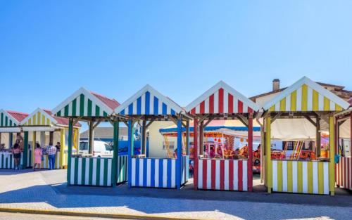 a group of colorful play structures in a playground at Le petit coin in Leiria