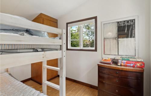 a bedroom with two bunk beds and a window at Holiday Home Ibsvej Solrød Strand Xi in Karlstrup Strand