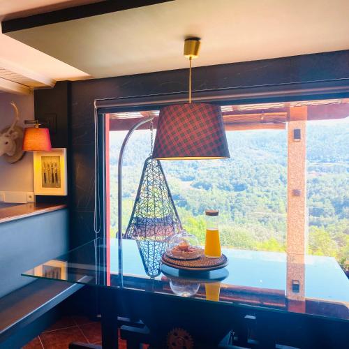 a kitchen with a glass counter top and a window at Quinta Cercas da Costa in Vieira do Minho