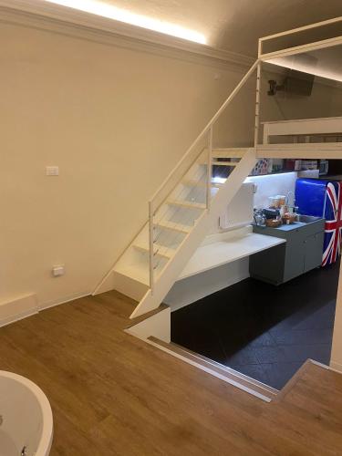a staircase in a room with a kitchen and a sink at Due Papi in Savona