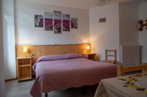a bedroom with a bed and two lamps on two tables at Camere vecchio borgo in Bormio