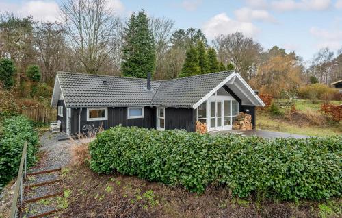 a black and white house with a yard at Cozy Home In Melby With Kitchen in Melby