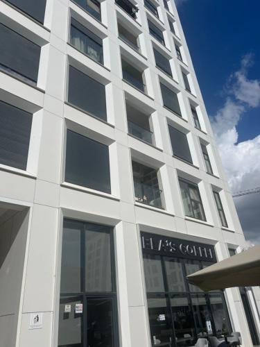 a tall white building with a lot of windows at Shehu Apartment in Tirana