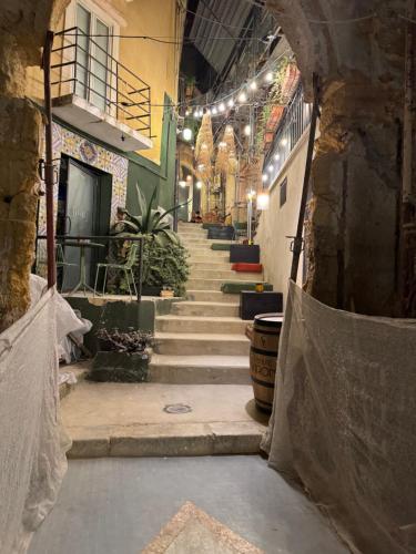 a hallway with stairs in a building with lights at Le Scalette del centro in Agrigento