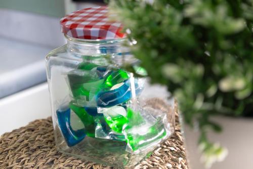 a glass jar filled with green and blue glass beads at Alice Apartments in Rho